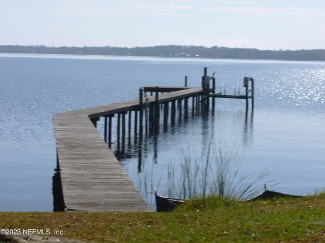 a view of a balcony with wooden floor and lake view