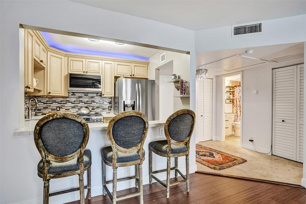 101 East McNab Road, Unit 407 Pompano Beach, FL 33060 - Photo 11 of 29 a dining room with furniture and wooden floor