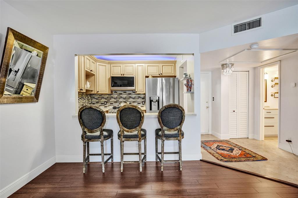 101 East McNab Road, Unit 407 Pompano Beach, FL 33060 - Photo 12 of 29 a view of dining room and wooden floor