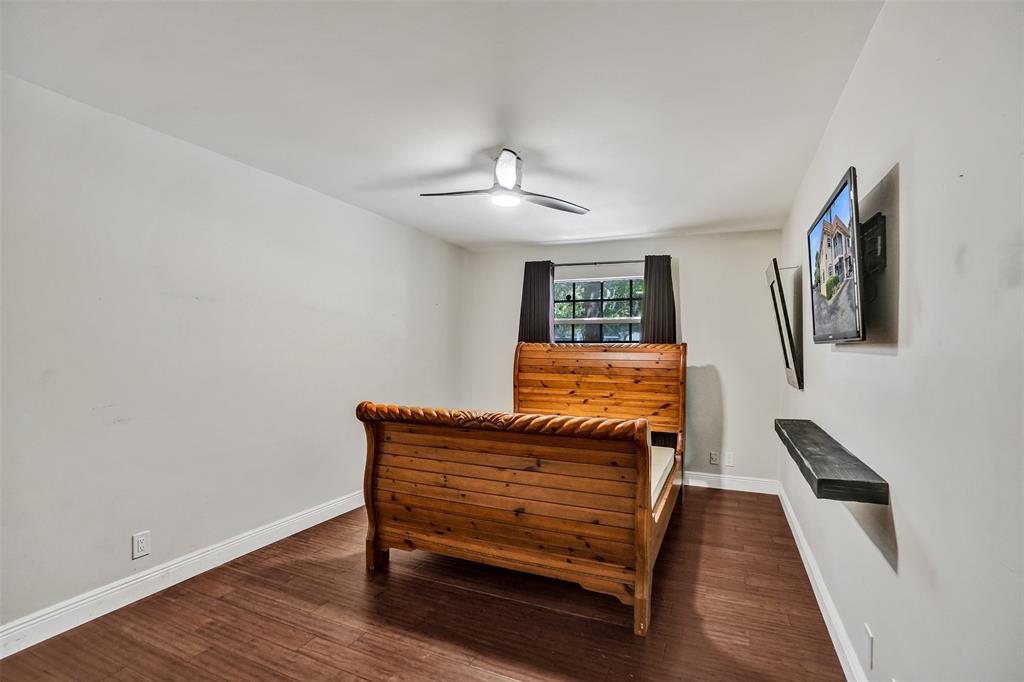 101 East McNab Road, Unit 407 Pompano Beach, FL 33060 - Photo 17 of 29 a bedroom with a bed and a chandelier