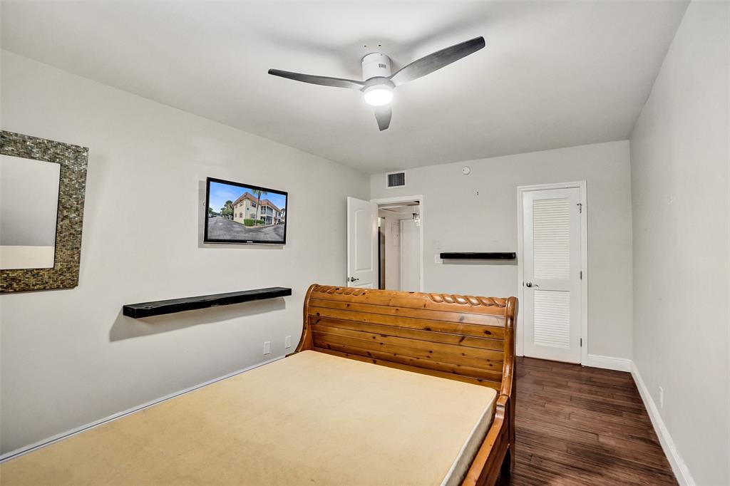 101 East McNab Road, Unit 407 Pompano Beach, FL 33060 - Photo 19 of 29 a bedroom with a bed and a dresser