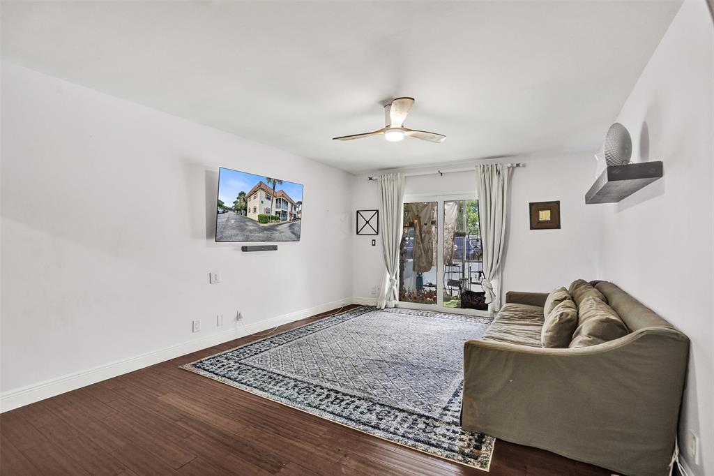 101 East McNab Road, Unit 407 Pompano Beach, FL 33060 - Photo 2 of 29 a living room with furniture and a window