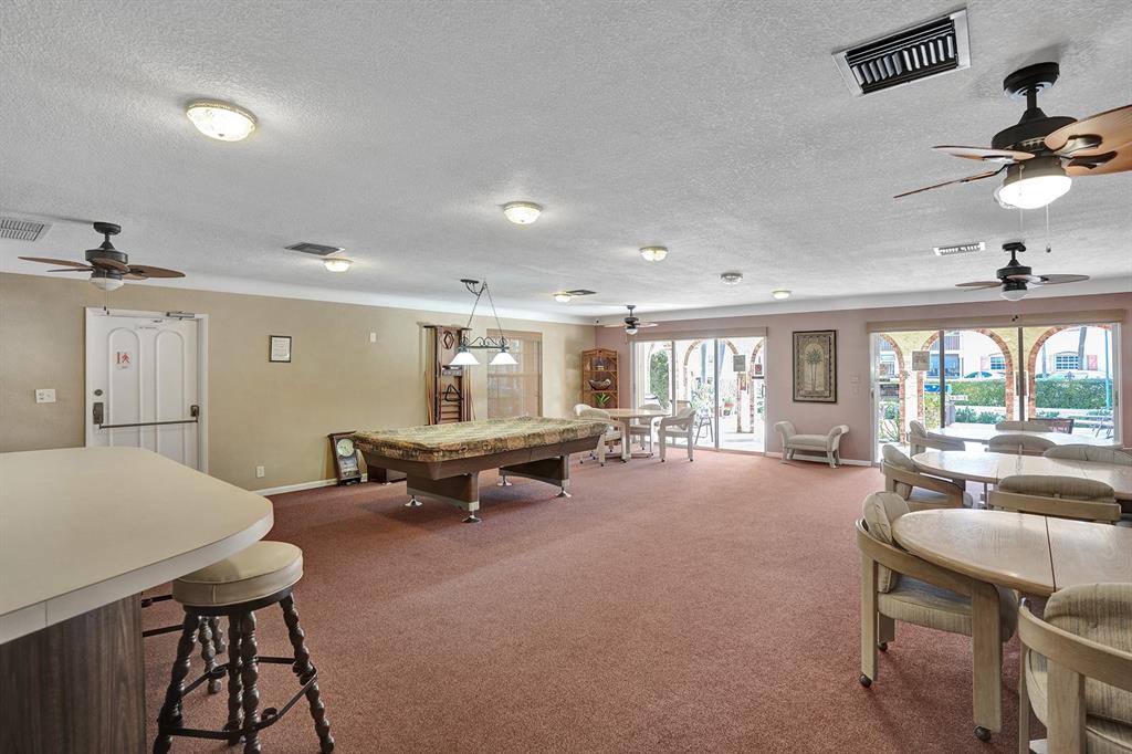 101 East McNab Road, Unit 407 Pompano Beach, FL 33060 - Photo 24 of 29 a living room with furniture and a large window
