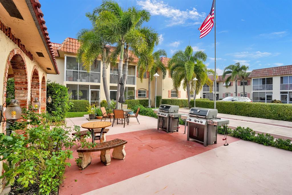 101 East McNab Road, Unit 407 Pompano Beach, FL 33060 - Photo 27 of 29 a view of a patio with couches table and chairs and potted plants