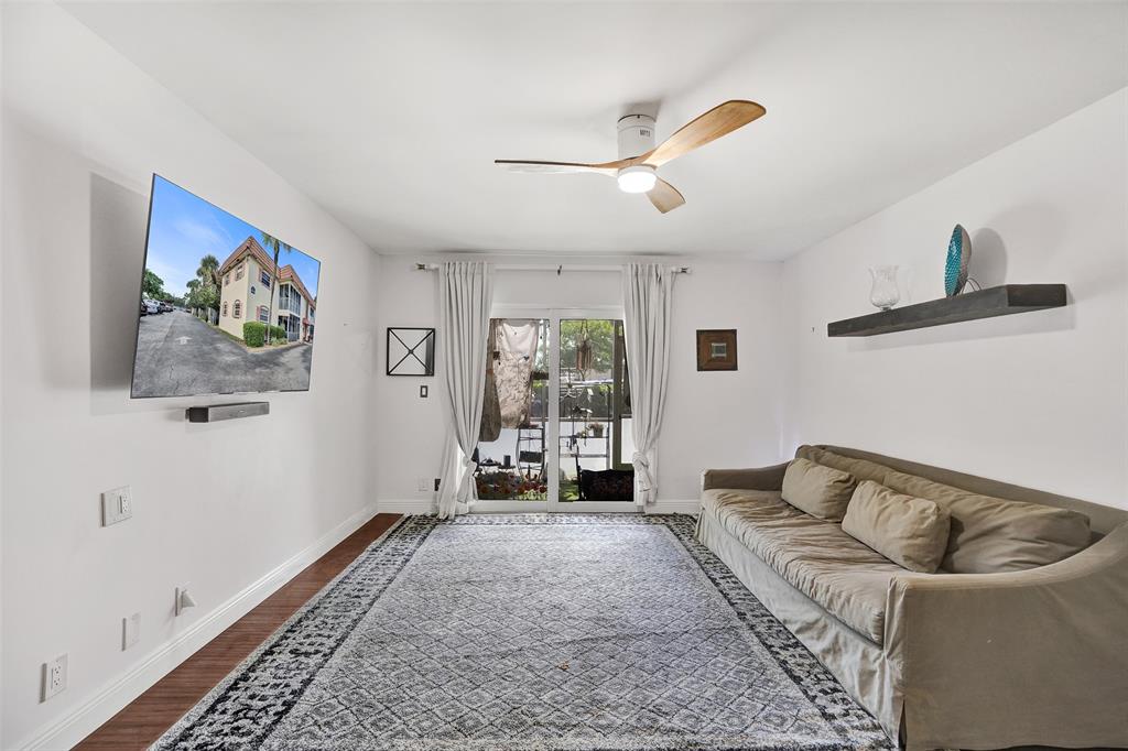 101 East McNab Road, Unit 407 Pompano Beach, FL 33060 - Photo 3 of 29 a living room with furniture and a large window