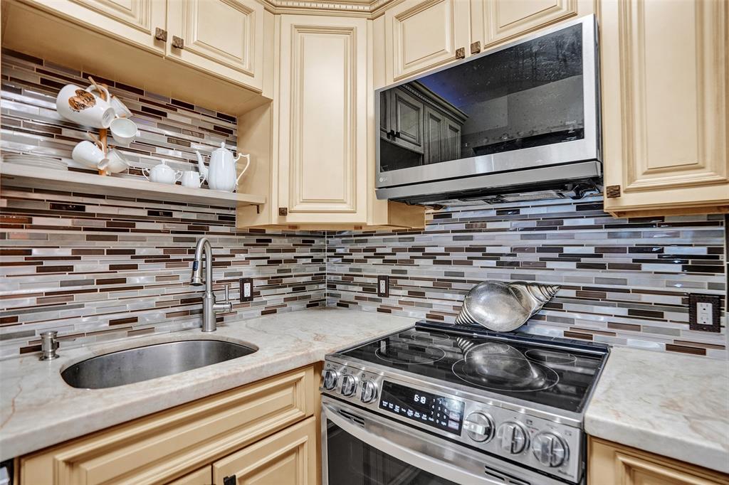 101 East McNab Road, Unit 407 Pompano Beach, FL 33060 - Photo 7 of 29 a kitchen with a stove and a microwave