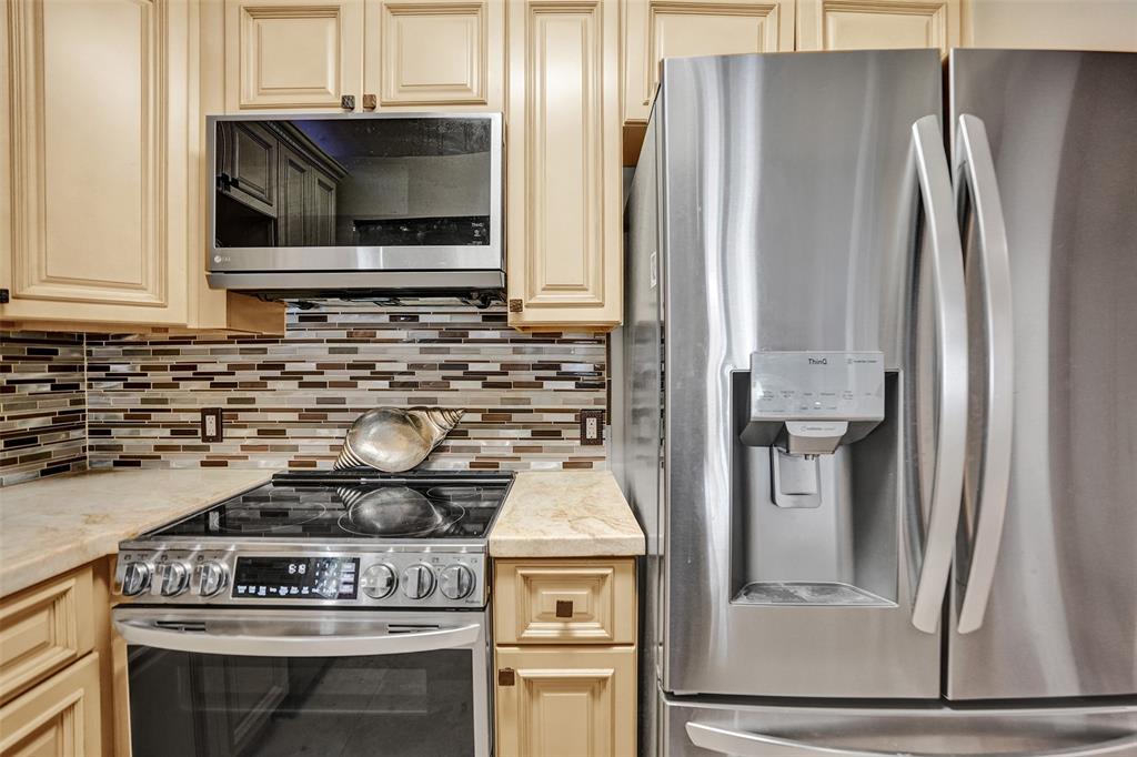 101 East McNab Road, Unit 407 Pompano Beach, FL 33060 - Photo 8 of 29 a kitchen with a stove and a microwave