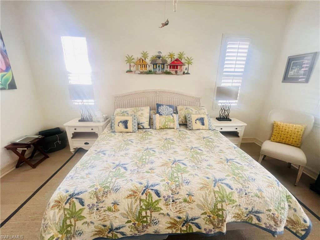 6574 Amarone Lane Naples, FL 34113 - Photo 20 of 44 a bedroom with a bed and a couch