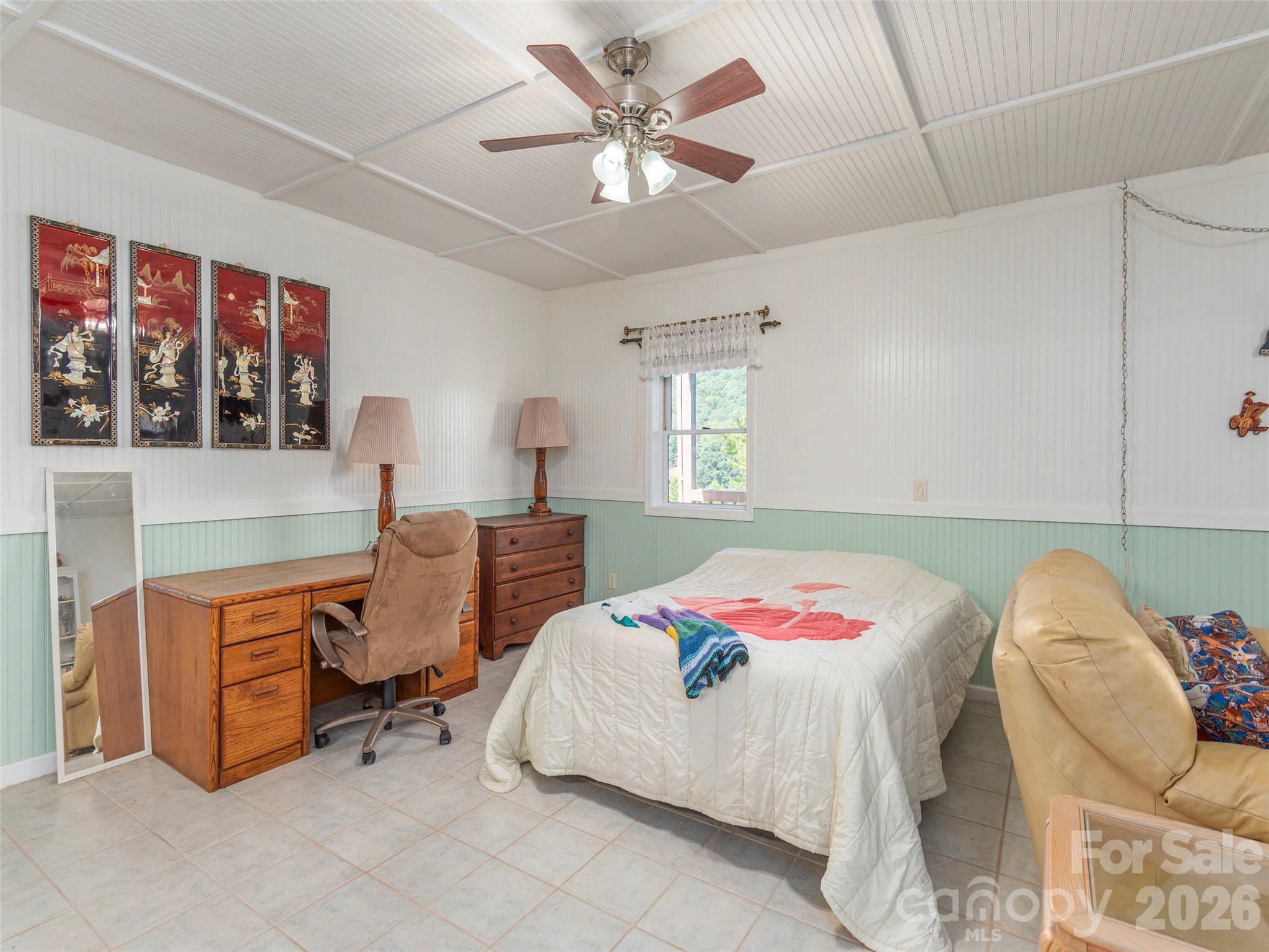 1120 Jacobs Branch Road Franklin, NC 28734 - Photo 21 of 36 a bedroom with a bed and a chandelier