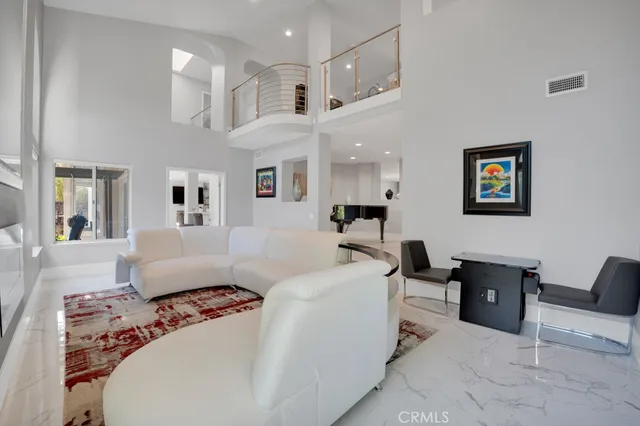 a very nice looking living room with a large window and wooden floor