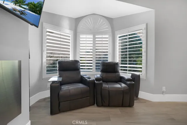a bedroom with furniture and a flat screen tv