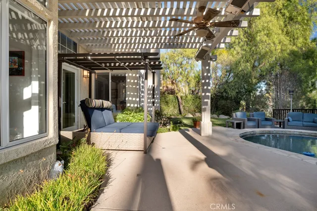 a view of a house with backyard and sitting area