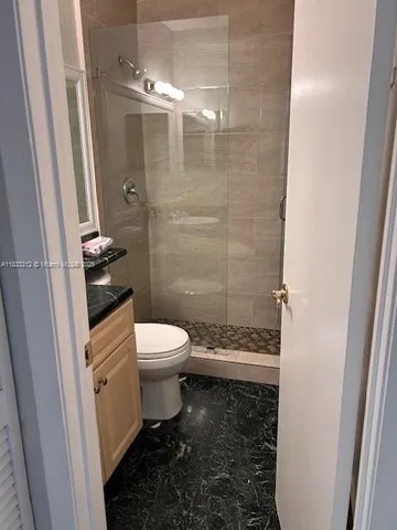 a bathroom with a toilet and a shower