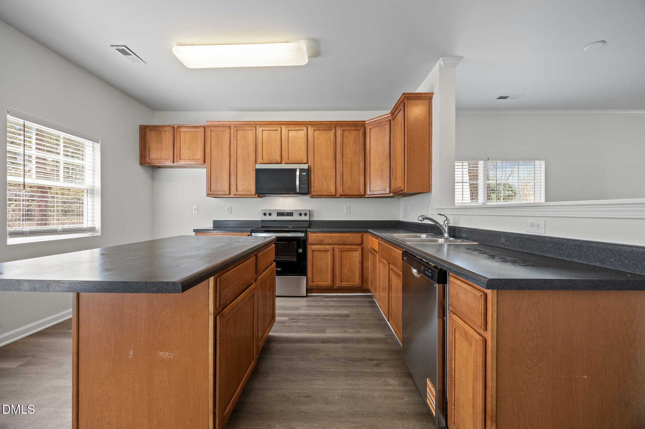 1071 Heritage Manor Drive Raleigh, NC 27610 - Photo 11 of 42 a kitchen with stainless steel appliances granite countertop a stove a sink and a microwave