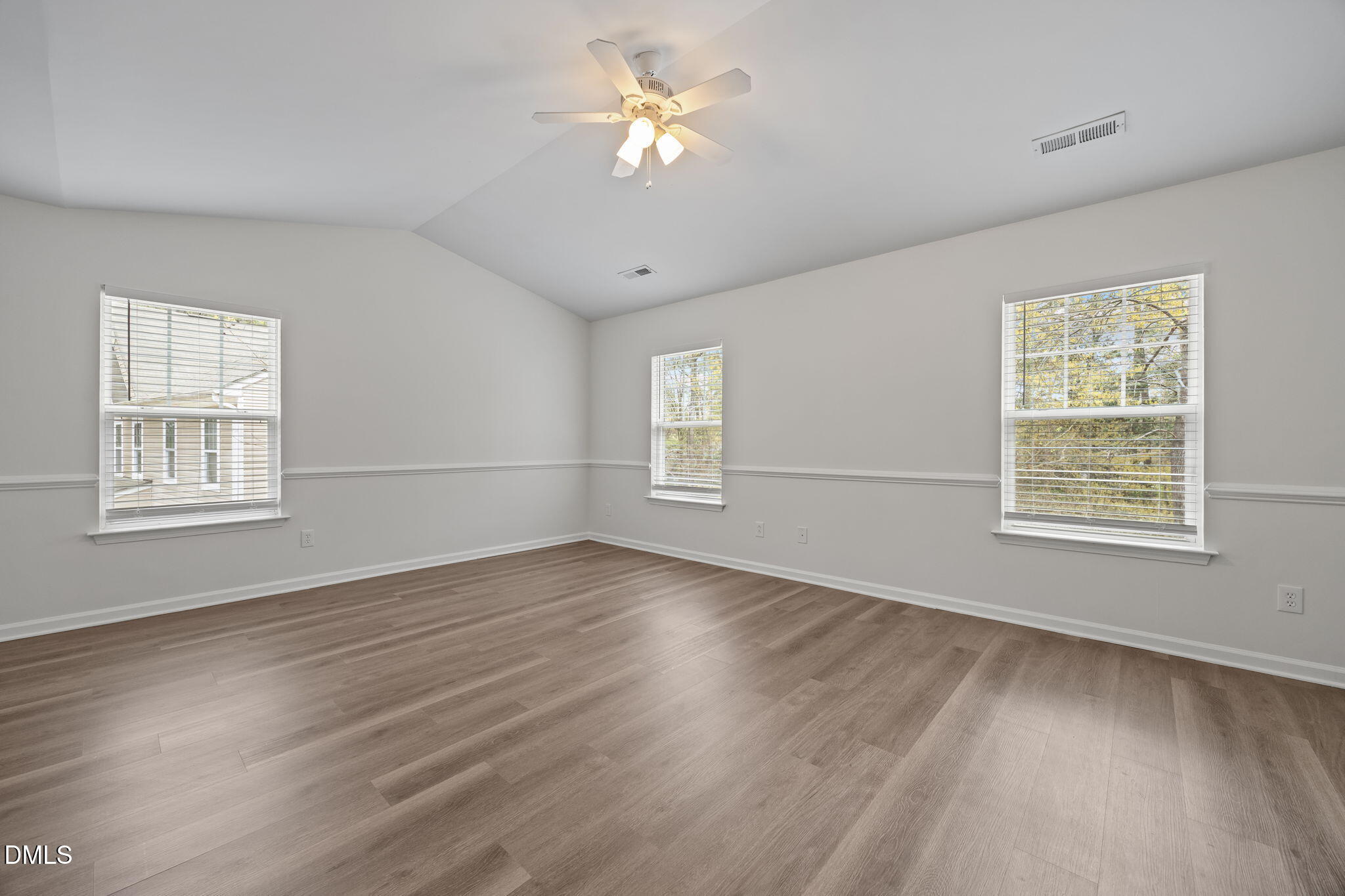 1071 Heritage Manor Drive Raleigh, NC 27610 - Photo 16 of 42 a view of an empty room with wooden floor and a window