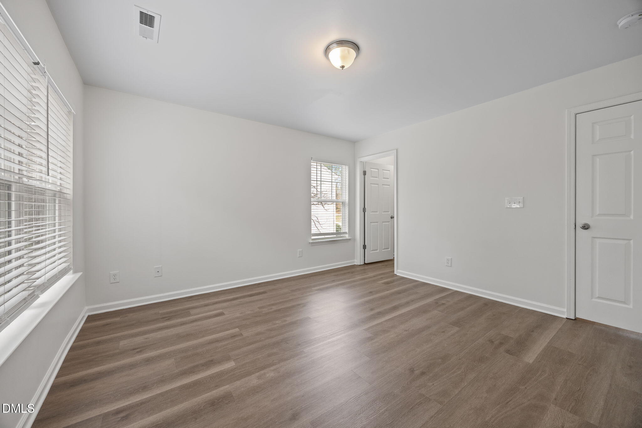 1071 Heritage Manor Drive Raleigh, NC 27610 - Photo 23 of 42 an empty room with wooden floor and window