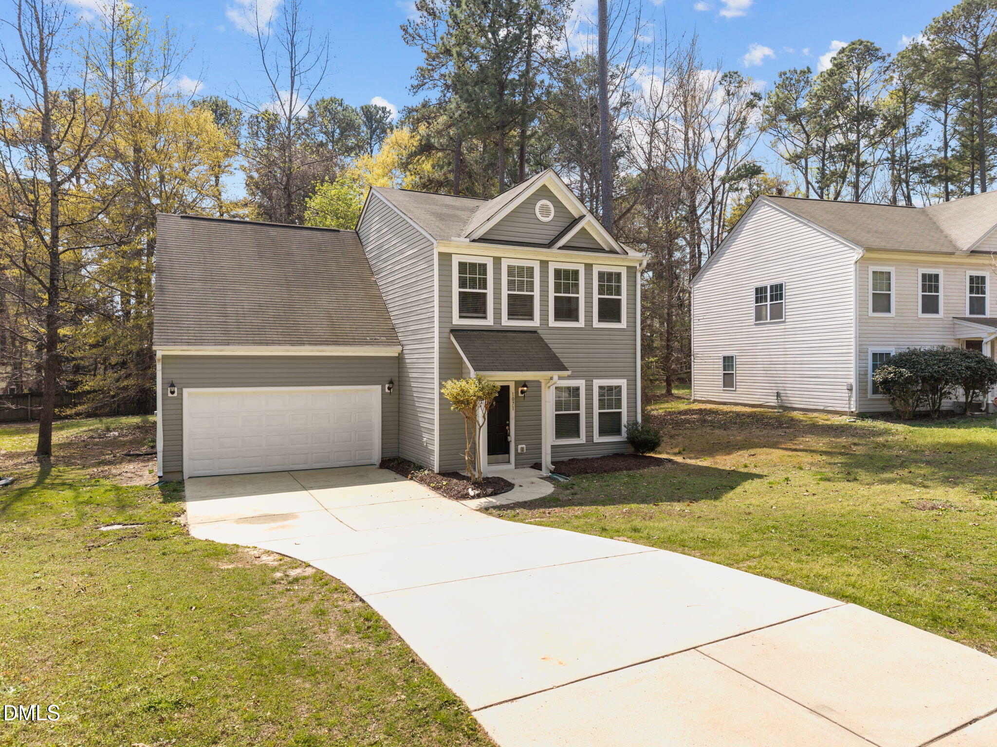 1071 Heritage Manor Drive Raleigh, NC 27610 - Photo 4 of 42 a front view of a house with yard and trees
