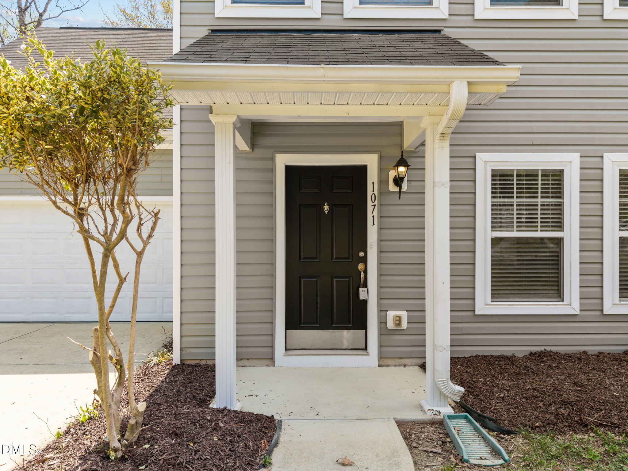 1071 Heritage Manor Drive Raleigh, NC 27610 - Photo 5 of 42 a front view of a house with a garden