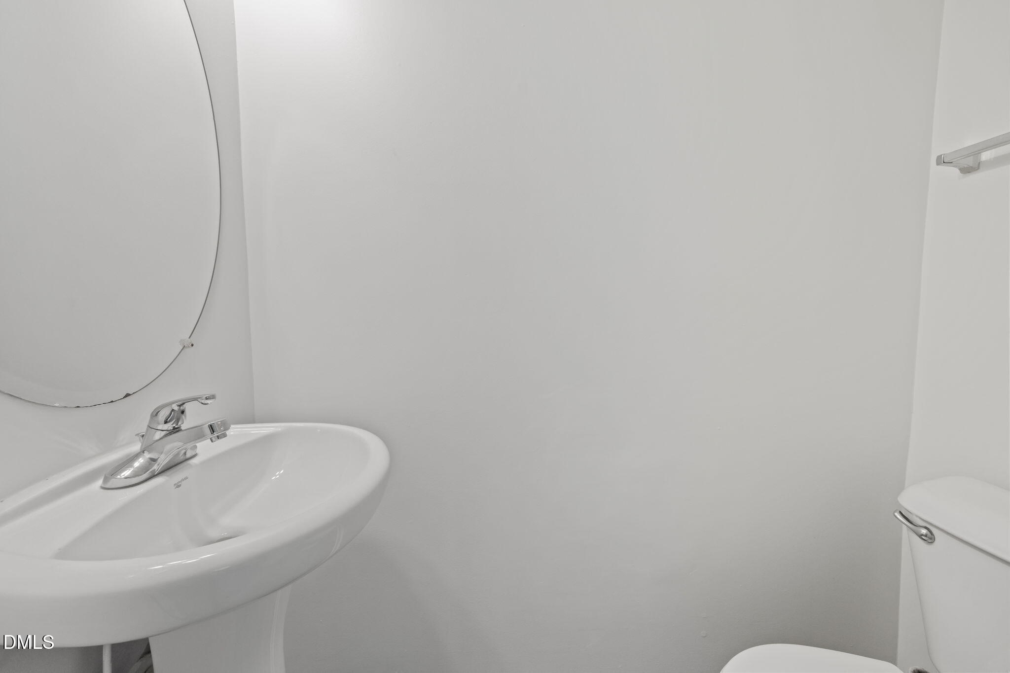 1071 Heritage Manor Drive Raleigh, NC 27610 - Photo 6 of 42 a bathroom with a sink a toilet and mirror