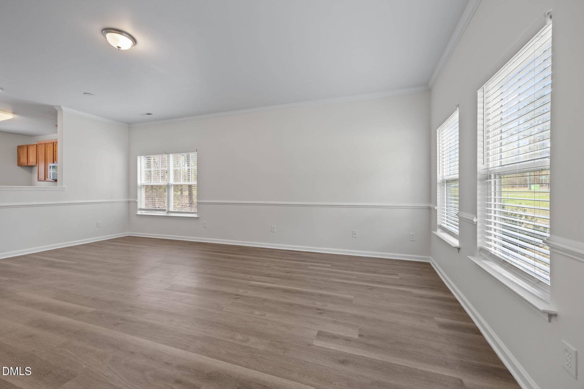 1071 Heritage Manor Drive Raleigh, NC 27610 - Photo 7 of 42 wooden floor in an empty room with a window