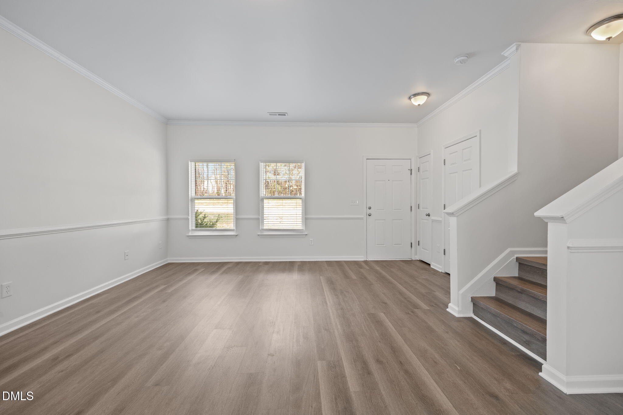 1071 Heritage Manor Drive Raleigh, NC 27610 - Photo 8 of 42 an empty room with wooden floor and windows