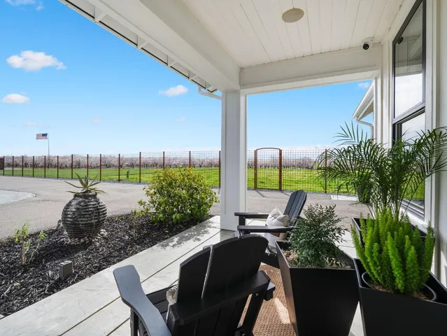 a kitchen with cabinets stainless steel appliances and wooden floor