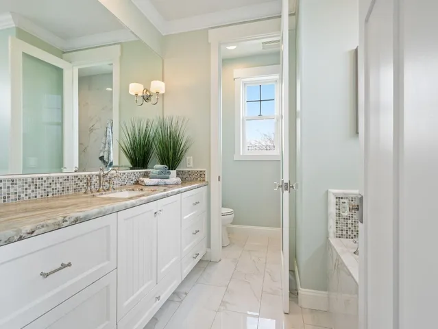 a bedroom with bed and a potted plant