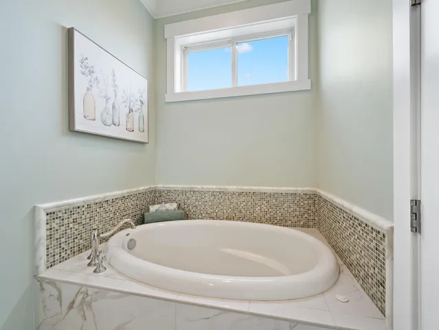 a kitchen with granite countertop a sink and dishwasher a stove top oven with white cabinets