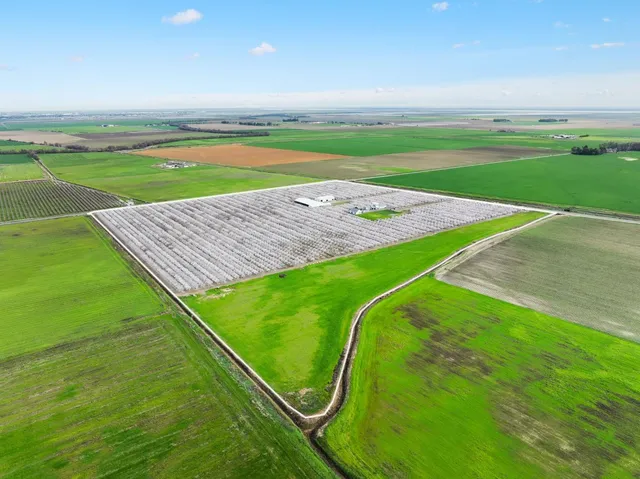 a view of a chairs and table in patio with a lake view