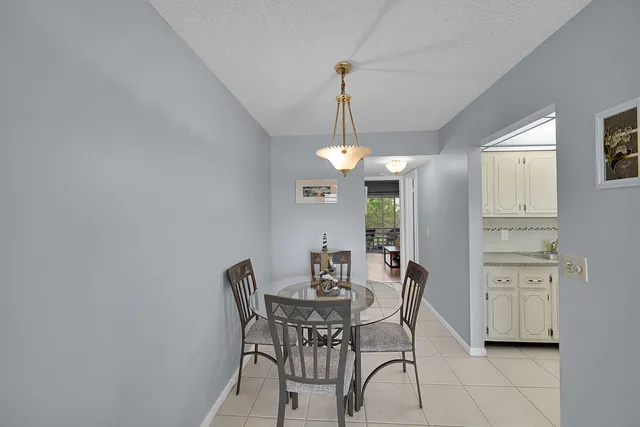 a view of a dining room with furniture and chandelier