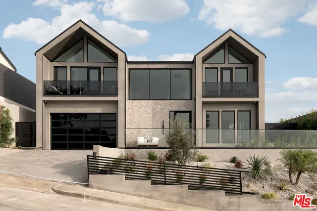 a front view of a house with garage