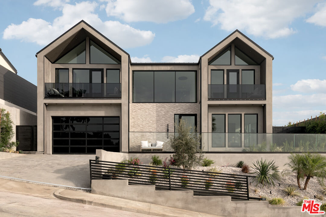 a front view of a house with garage