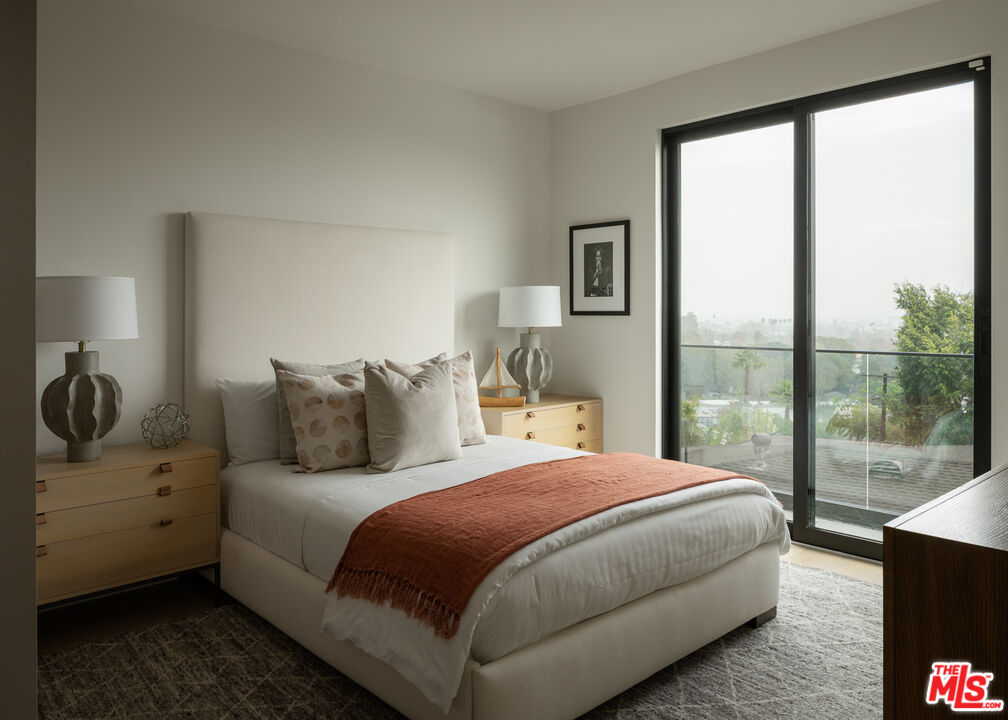 9919 Girla Way Los Angeles, CA 90064 - Photo 22 of 31 a bedroom with a large bed and a large window