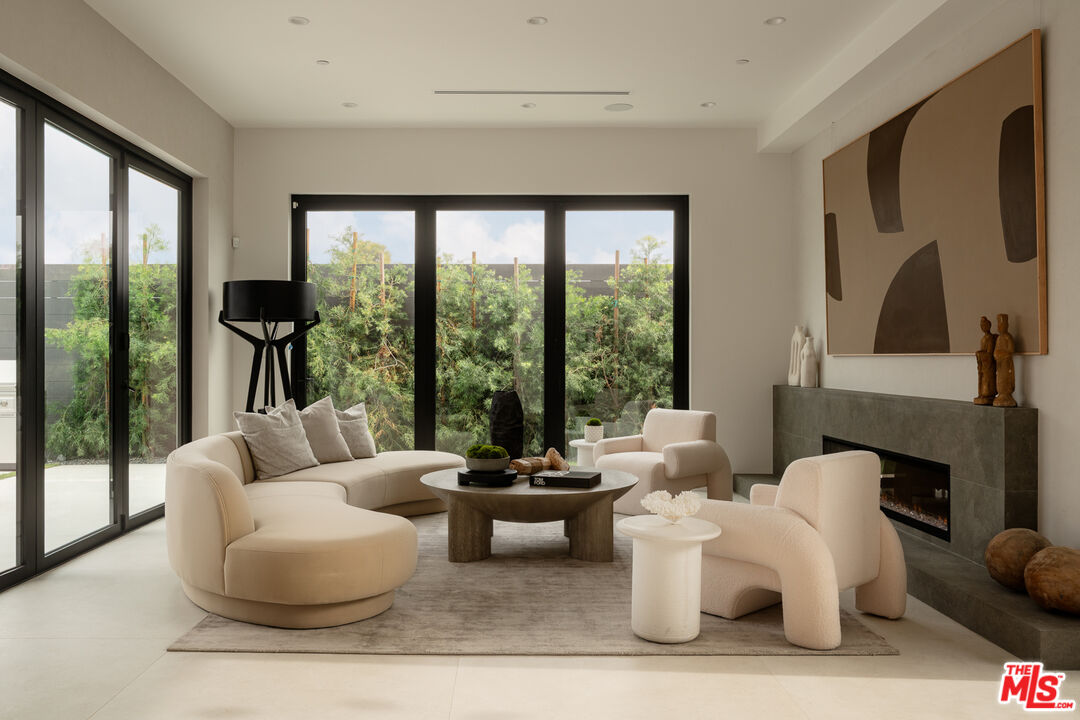 9919 Girla Way Los Angeles, CA 90064 - Photo 9 of 31 a living room with fireplace furniture and a large window