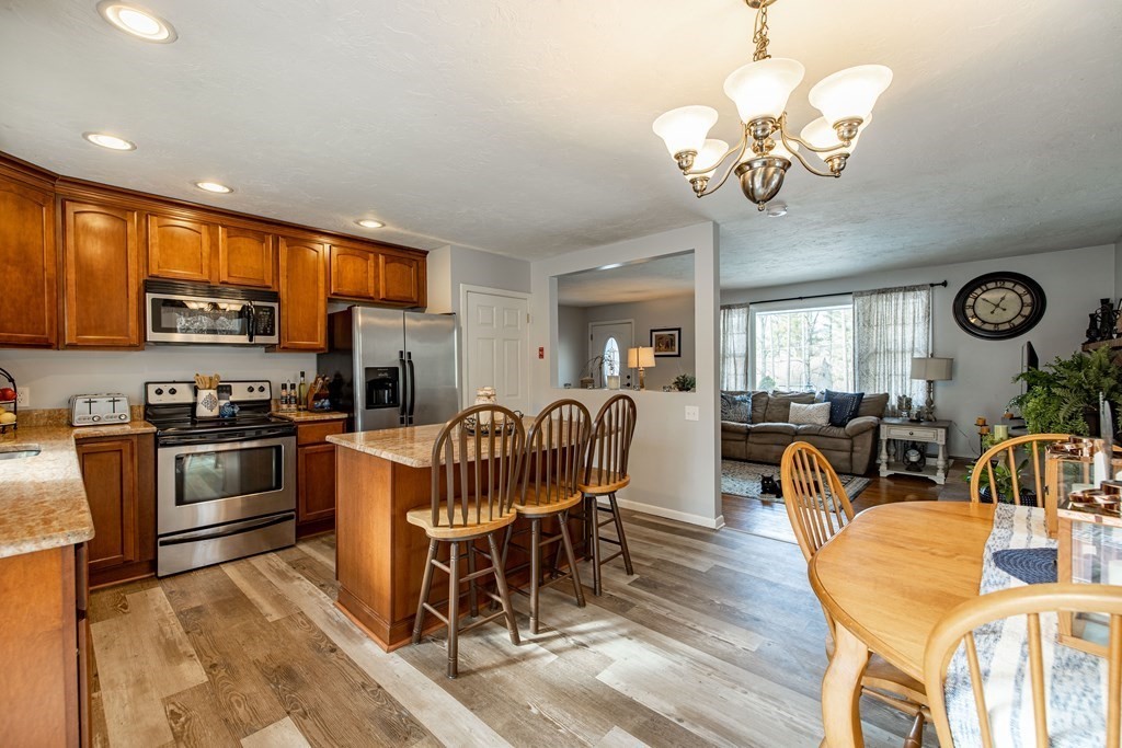 74 Walker Pond Road Sturbridge, MA 01566 - Photo 3 of 42 a view of a dining room with furniture and wooden floor