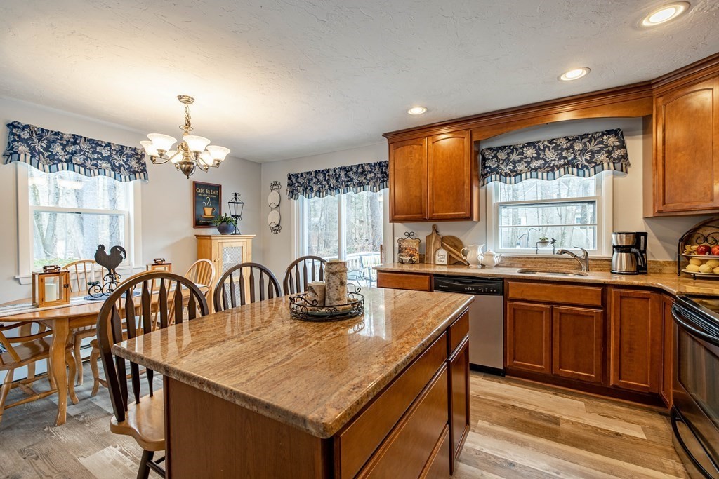 74 Walker Pond Road Sturbridge, MA 01566 - Photo 4 of 42 a kitchen with a table chairs sink and cabinets