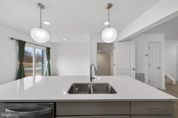 a view of a center island and chandelier