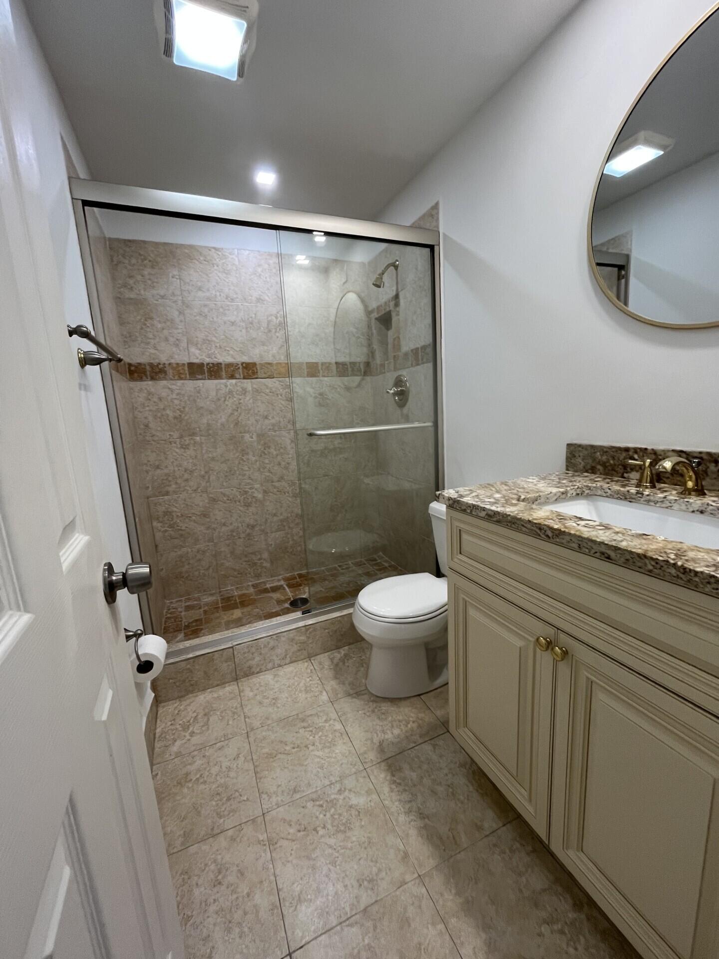 55 Southwest 2nd Avenue, Unit 2030 Boca Raton, FL 33432 - Photo 9 of 14 a bathroom with a granite countertop sink toilet and shower