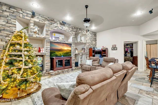 a living room with fireplace furniture and a flat screen tv