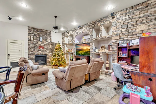a living room with fireplace furniture and a flat screen tv