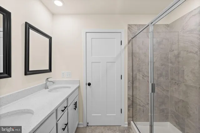 a bathroom with a shower sink and mirror