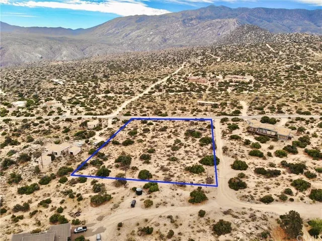 an aerial view of residential houses with city view