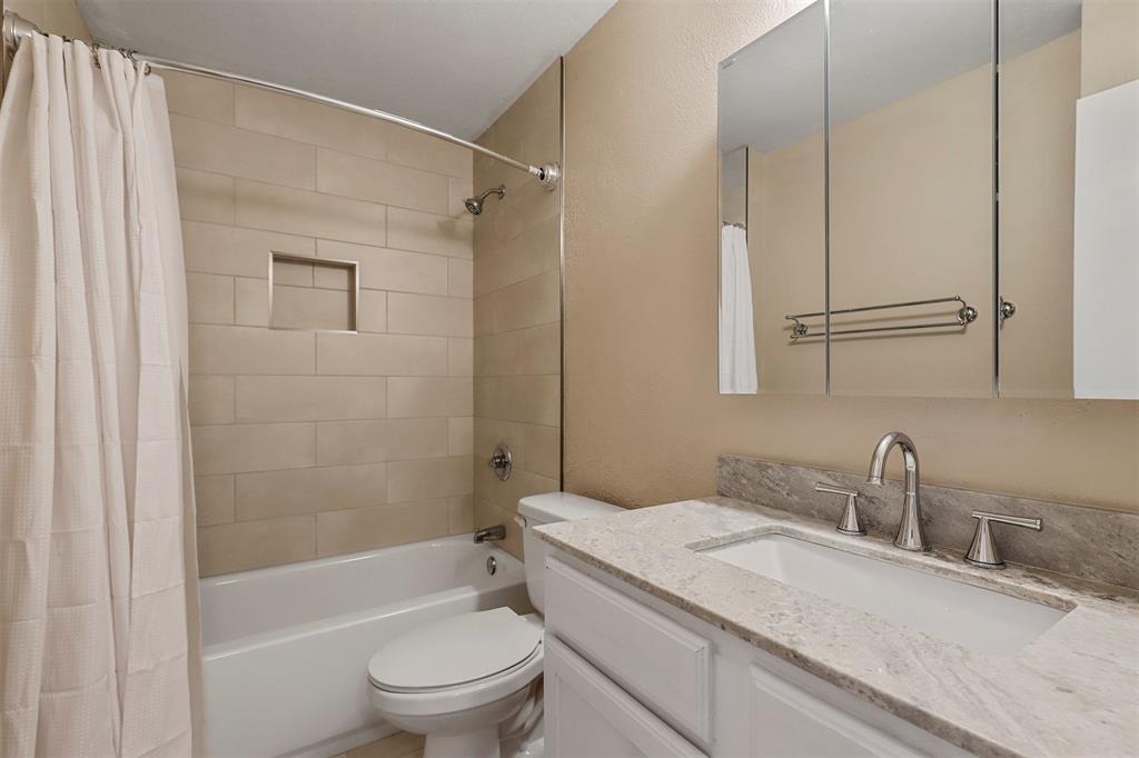 2801 Skyline Drive, Unit A Sansom Park, TX 76114 - Photo 12 of 16 a bathroom with a granite countertop sink toilet and shower