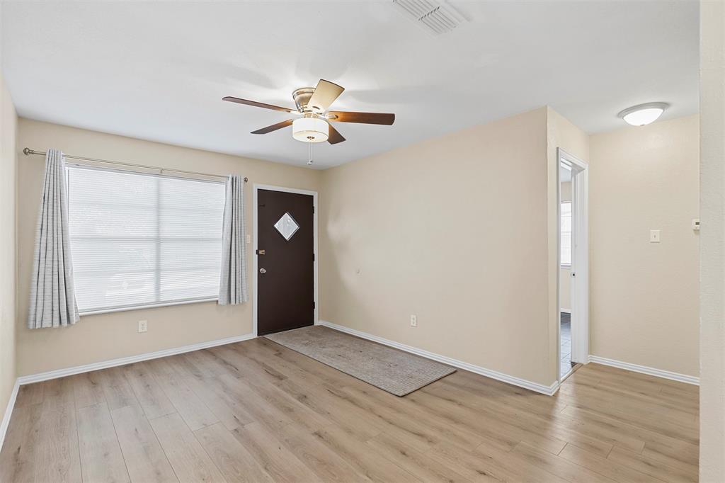 2801 Skyline Drive, Unit A Sansom Park, TX 76114 - Photo 4 of 16 an empty room with wooden floor closet and windows