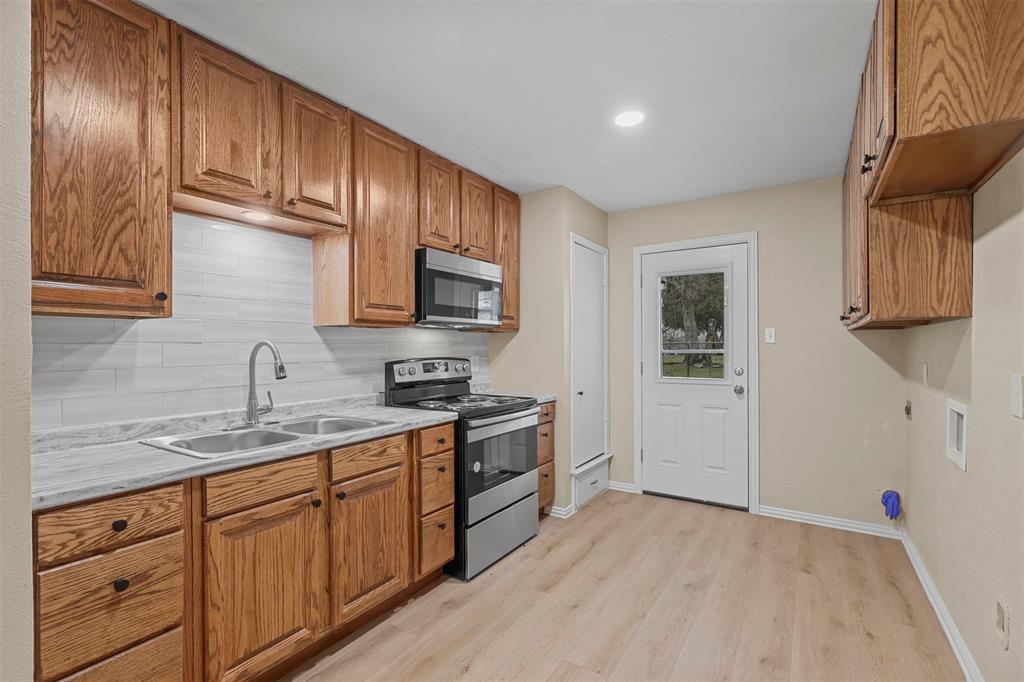 2801 Skyline Drive, Unit A Sansom Park, TX 76114 - Photo 7 of 16 a kitchen with stainless steel appliances granite countertop a sink stove and cabinets