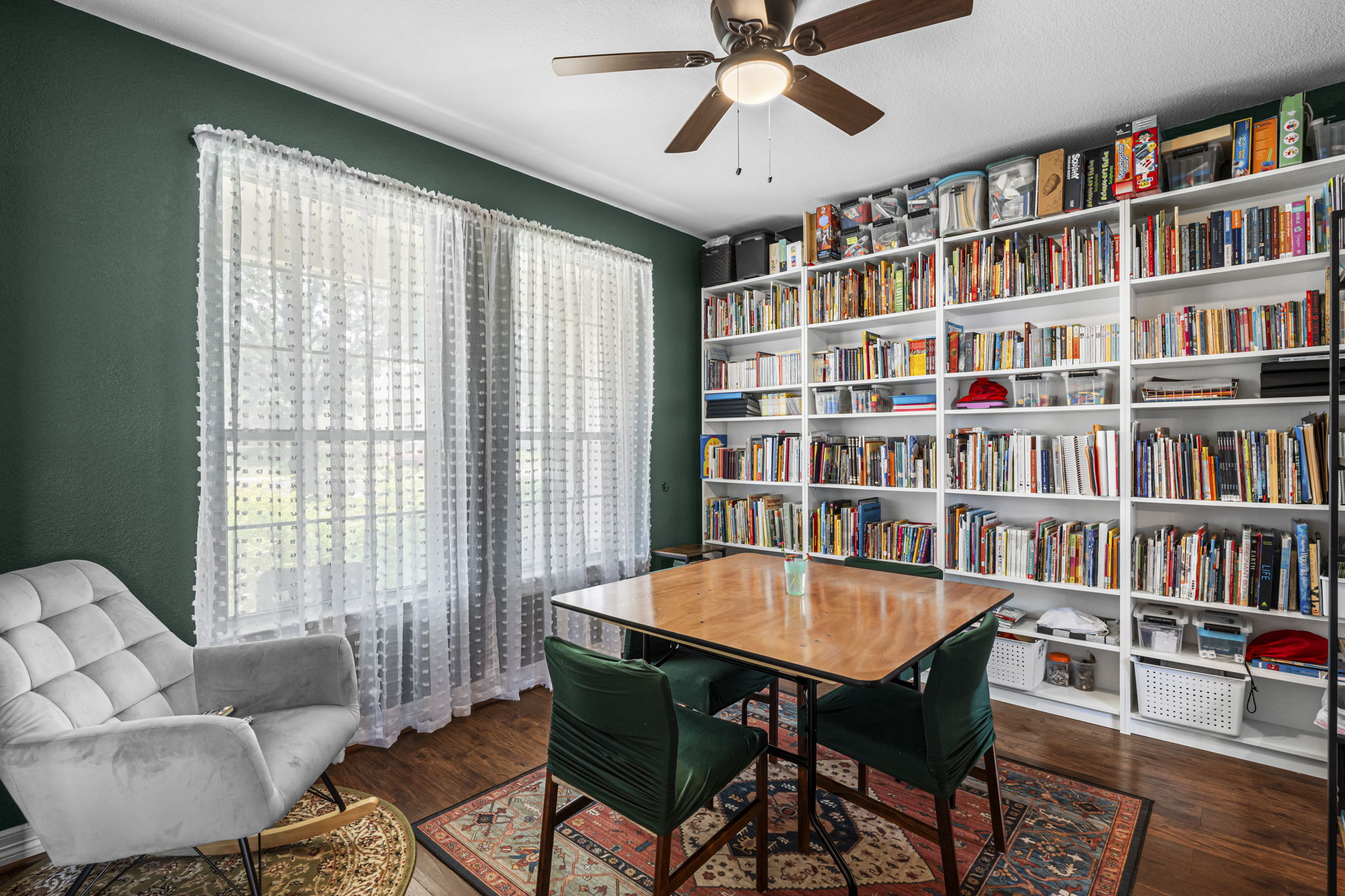 454 Fall Circle Kyle, TX 78640 - Photo 3 of 39 Ample natural light illuminates this cozy study, complete with extensive built-in shelving.
