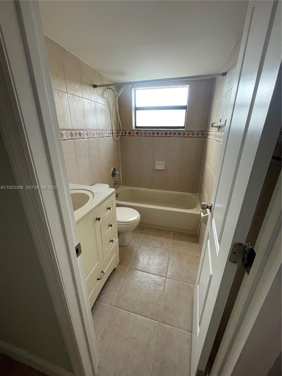 10897 Northwest 7th Street, Unit 1429 Miami, FL 33172 - Photo 11 of 17 a bathroom with a sink a toilet and shower