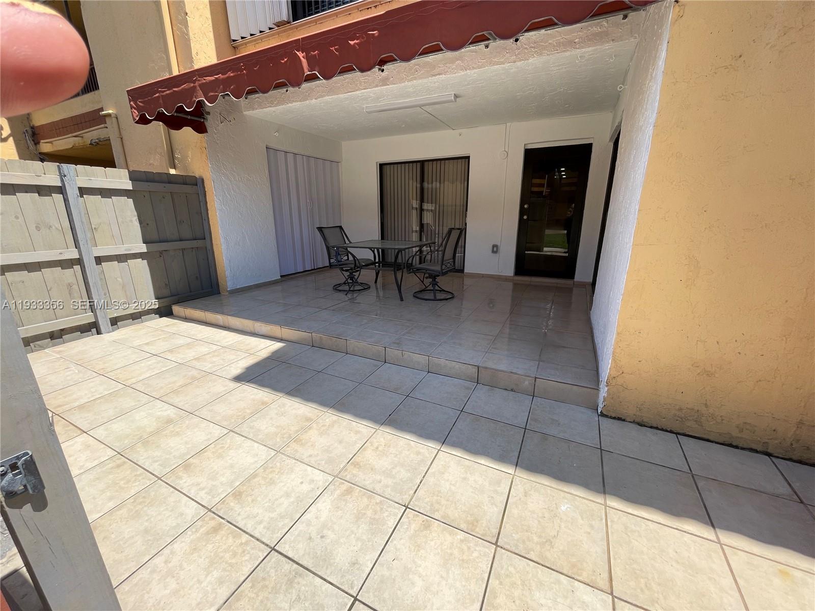 10897 Northwest 7th Street, Unit 1429 Miami, FL 33172 - Photo 14 of 17 a view of a patio with table and chairs and potted plants