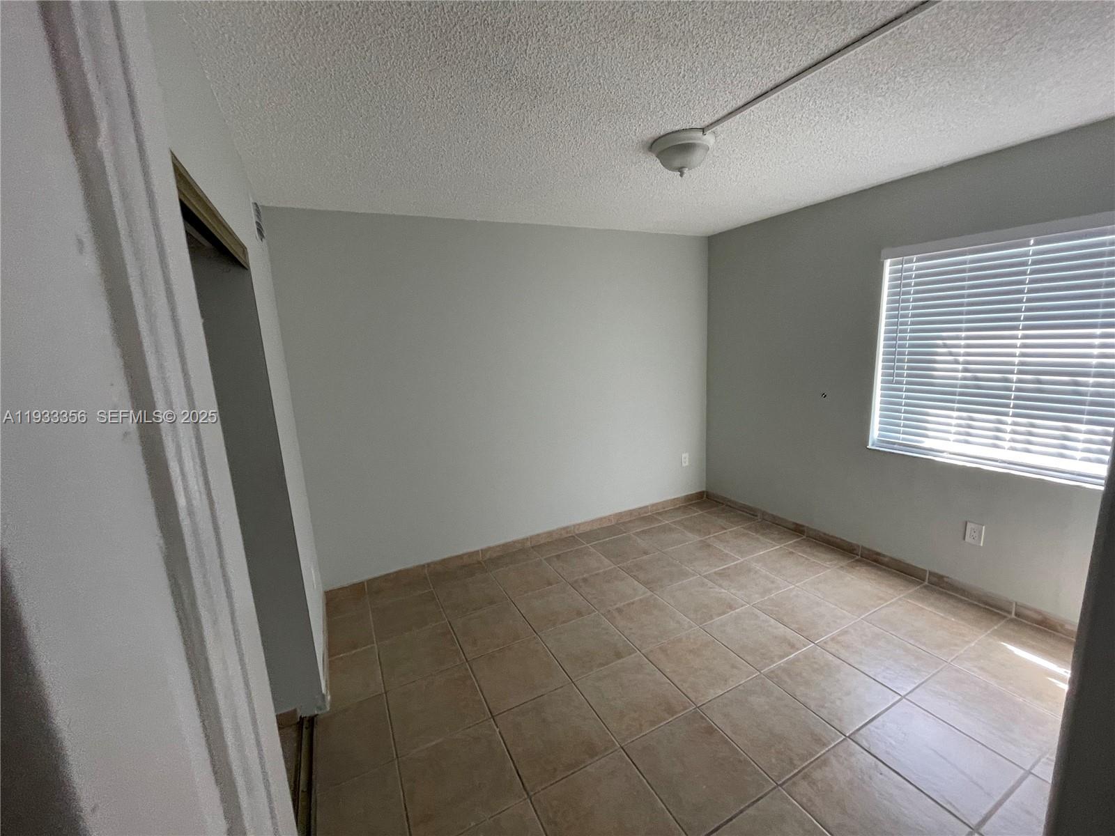 10897 Northwest 7th Street, Unit 1429 Miami, FL 33172 - Photo 8 of 17 a view of an empty room with a window