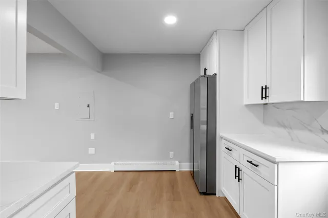 a view of a kitchen with a sink and refrigerator